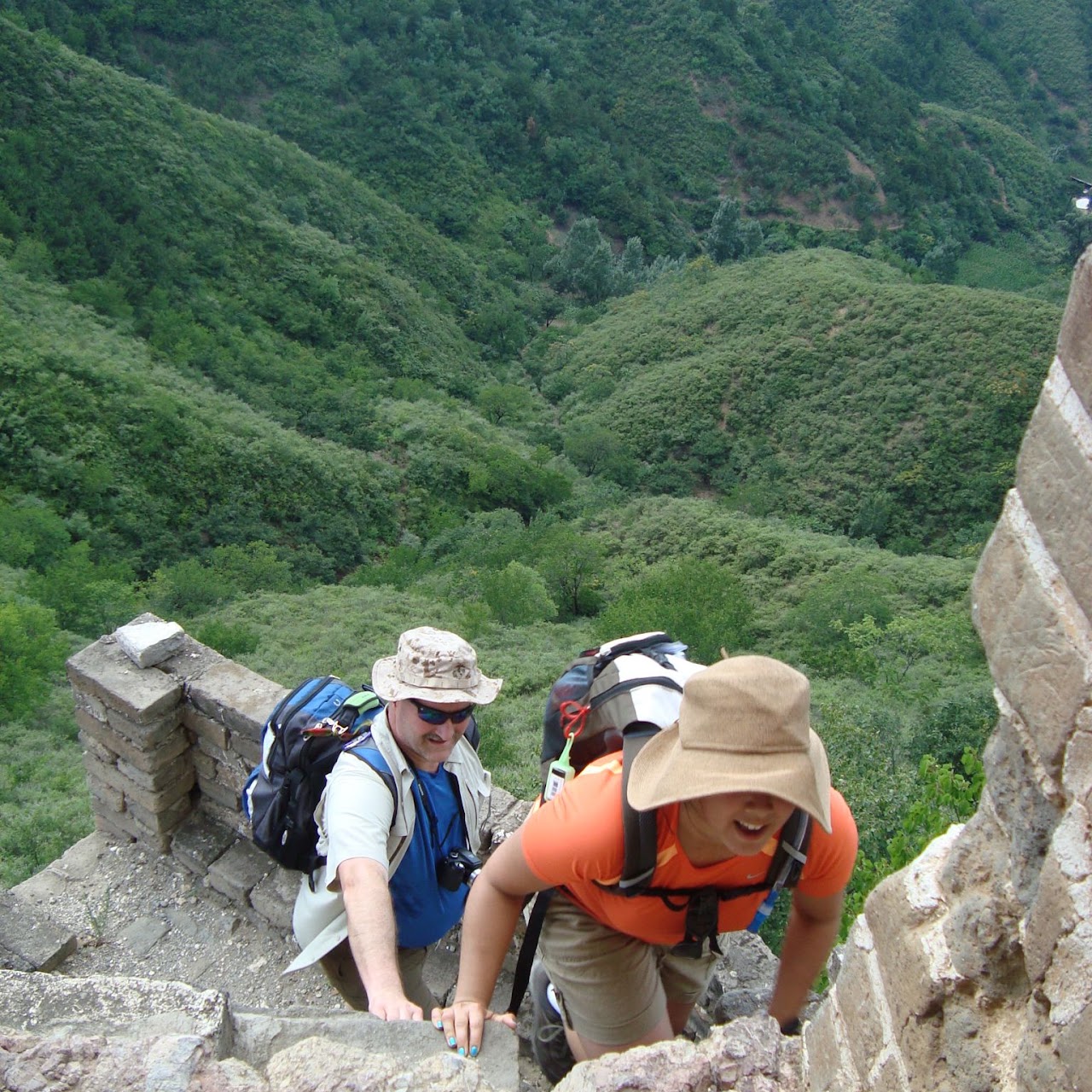 Hikers climbing a rugged Great Wall trail