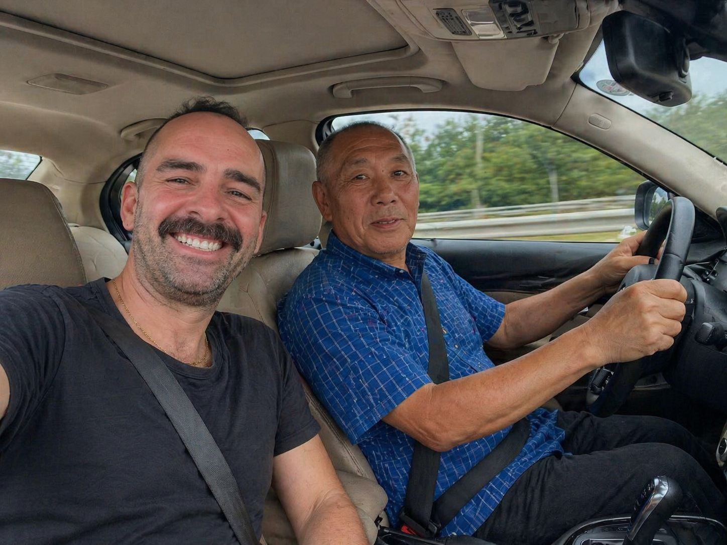 Mr. Wang driving with a customer during pickup for the Gubeikou Great Wall tour